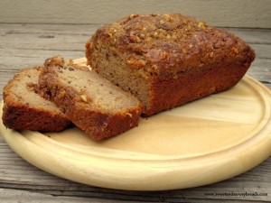 Sliced applesauce walnut bread on wood tray