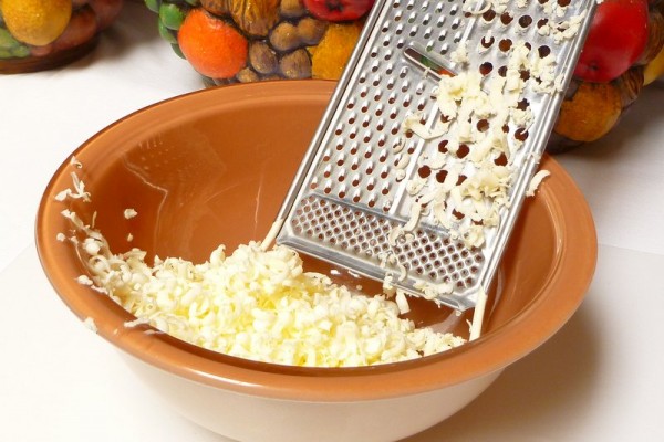 Grating frozen butter into a bowl