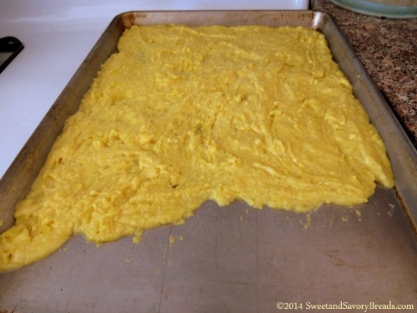 cornbread batter spread on sheet pan