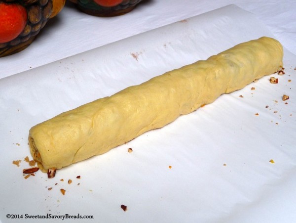 Crescent roll dough filled and ready for slicing